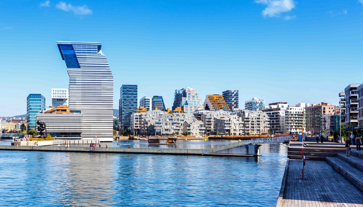 ALT text: Modern waterfront cityscape with a uniquely designed high-rise building