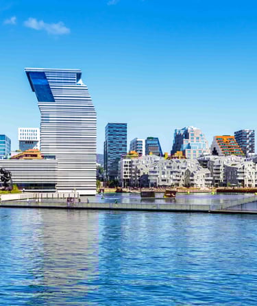 ALT text: Modern waterfront cityscape with a uniquely designed high-rise building