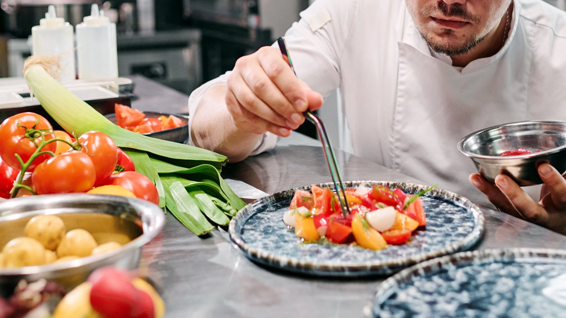 A chef placing the food on the plates