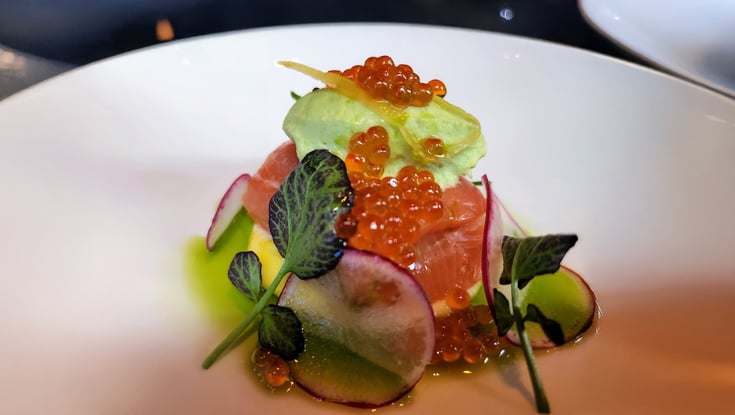 Dish with radish, greens, and salmon roe served in Oslo.