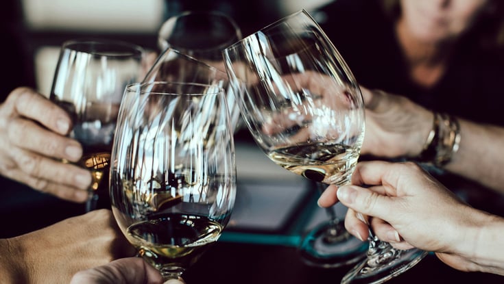 People toasting with wine glasses in Oslo.