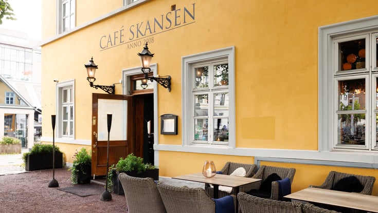 Café Skansen exterior with outdoor seating in Oslo.