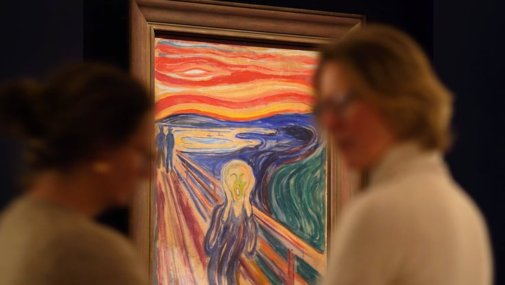 People viewing an artwork in a gallery.