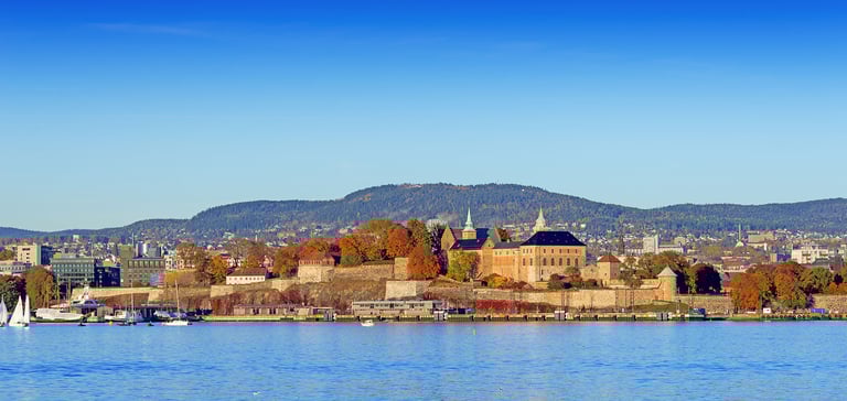 Scenic view of Akershus Fortress in Oslo by the waterfront.
