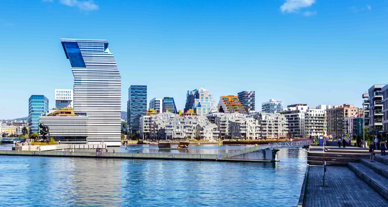 ALT text: Modern waterfront cityscape with a uniquely designed high-rise building