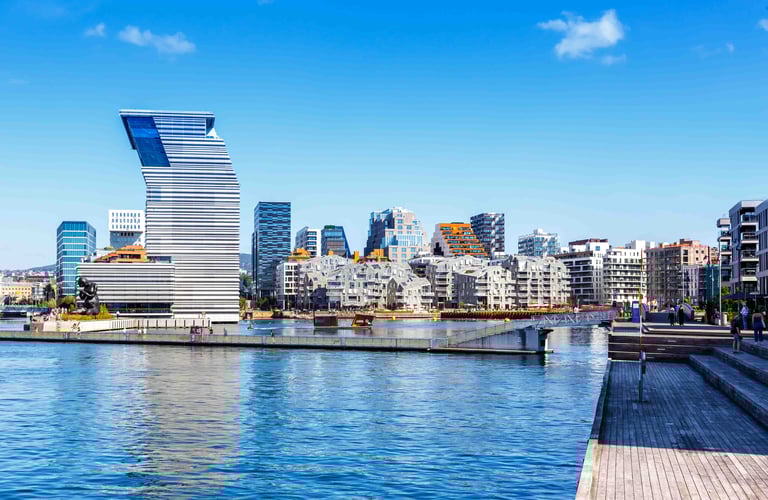 ALT text: Modern waterfront cityscape with a uniquely designed high-rise building