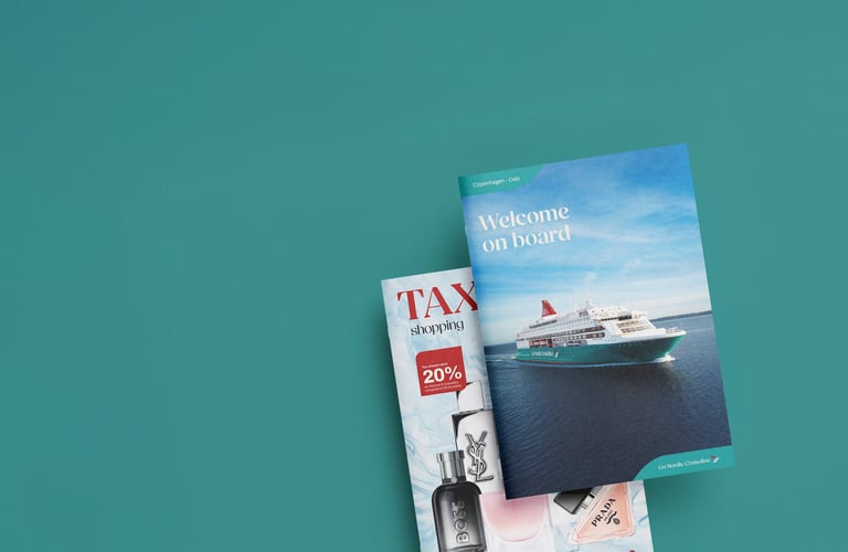 Promotional brochures featuring a cruise ship and tax-free shopping offers