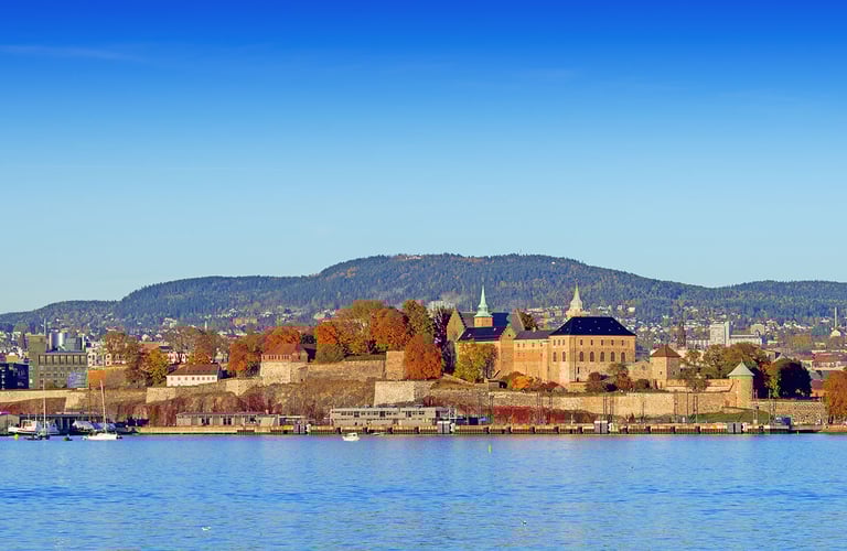 Scenic view of Akershus Fortress in Oslo by the waterfront.